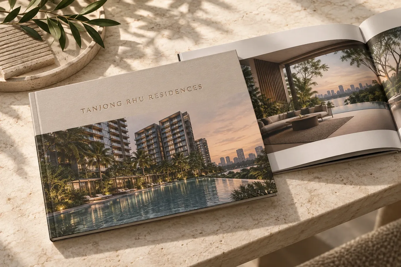 Artistic impression of the Tanjong Rhu Residences e-brochure lying open on a stone table, showing the cover and an interior spread